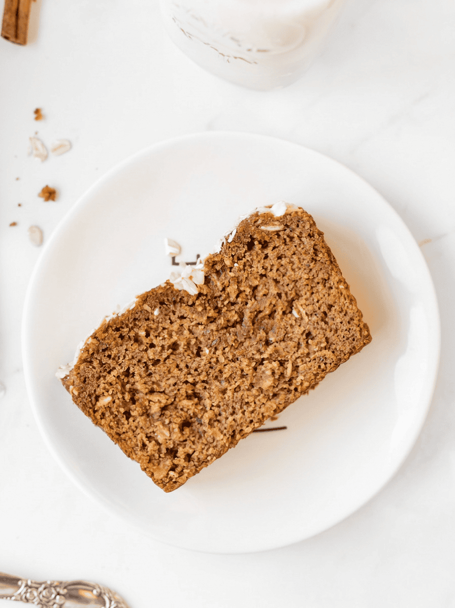 A slice of gluten free pumpkin bread on a small plate. 