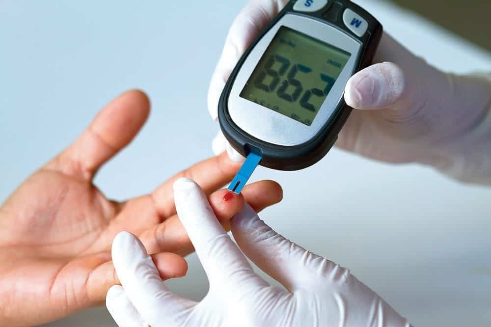 Blood glucose meter testing blood sugar level for diabetes management.