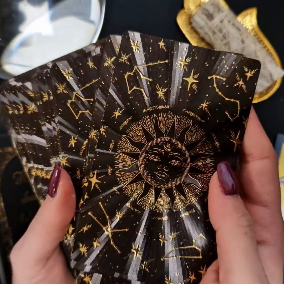 Back of gold foil tarot cards with decorative celestial design