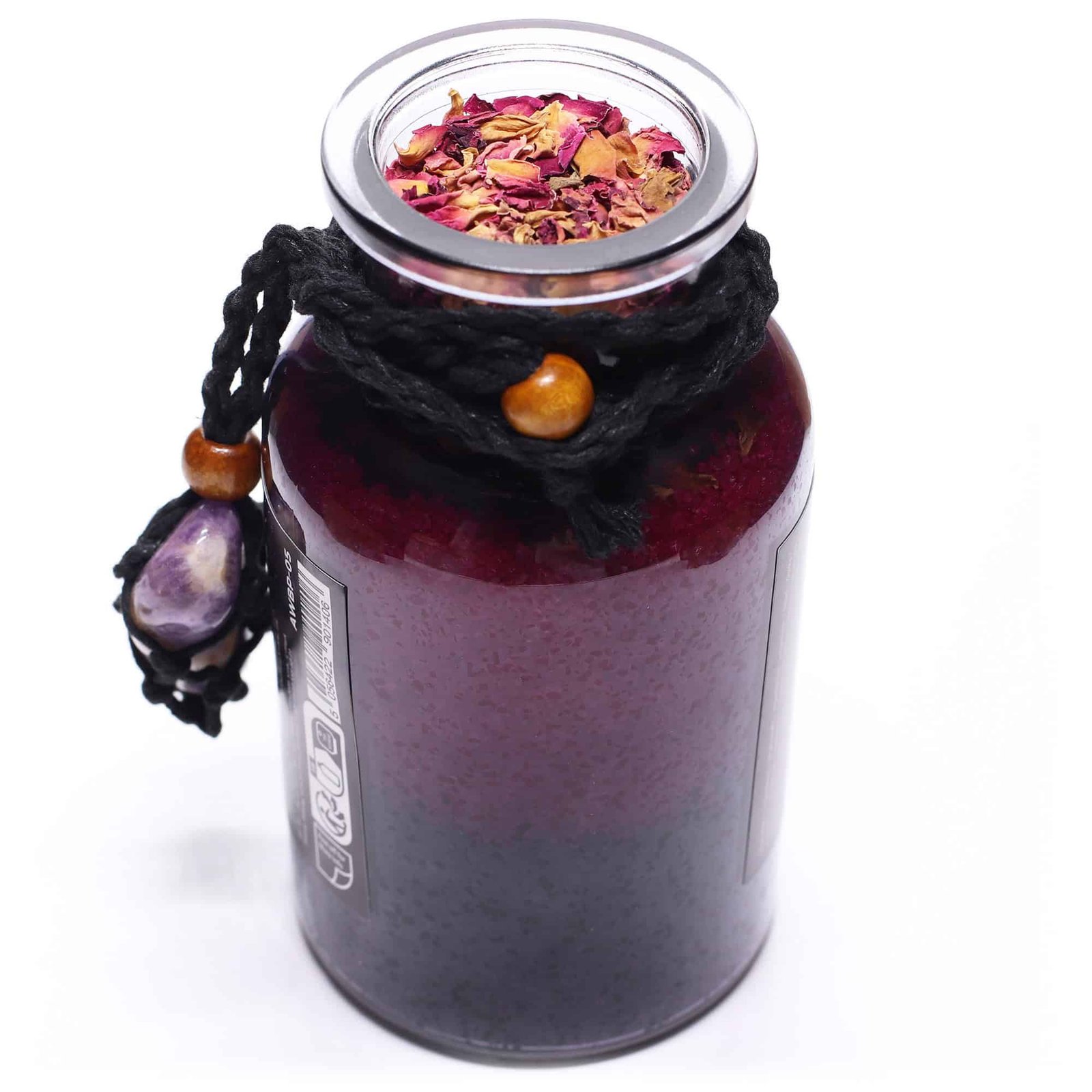Vegan antler candle with dried flower petals in a glass jar, wrapped with black cord and decorated with purple stone and wooden beads, perfect for eco-friendly gifts or home decor.