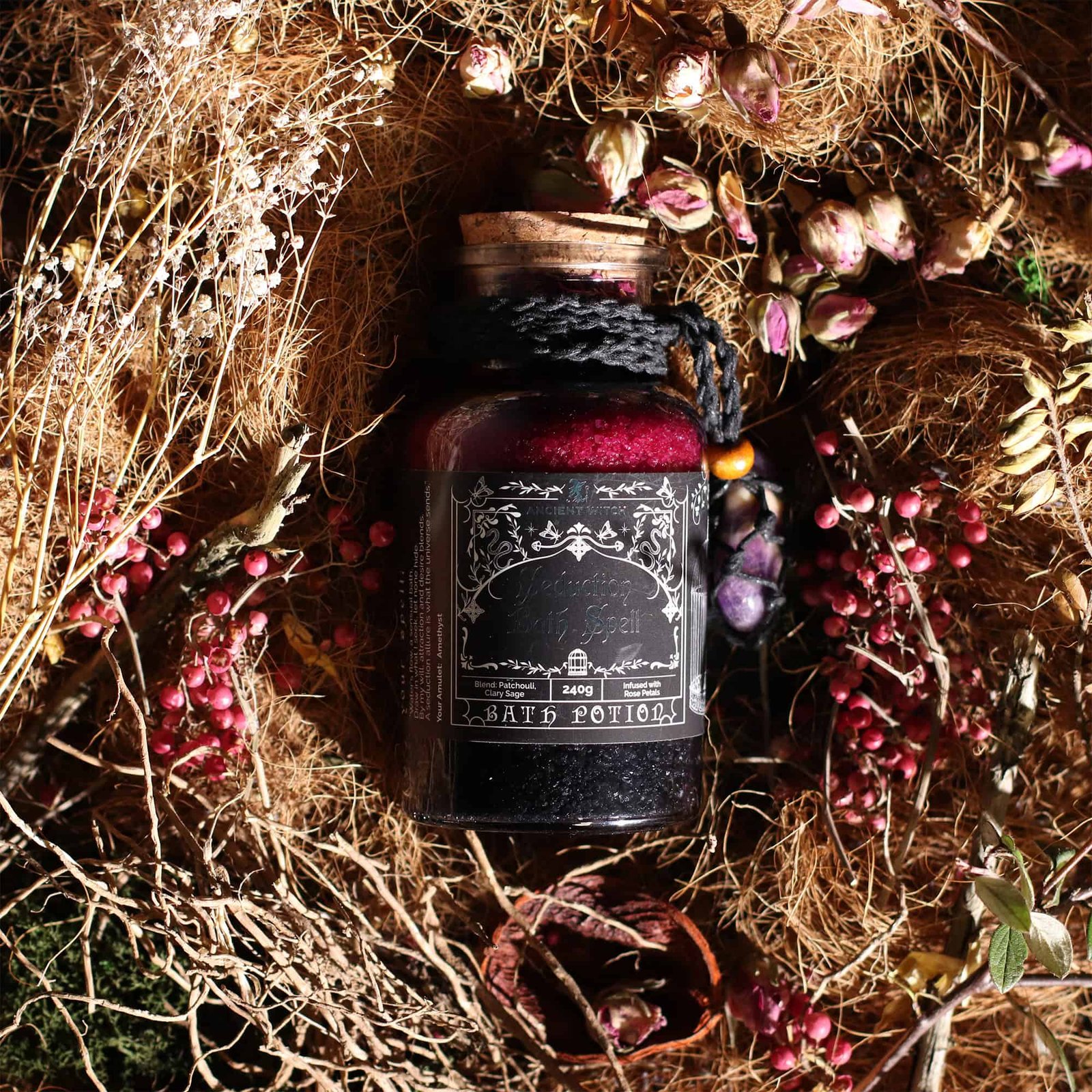 Dark bath potion with herbal ingredients in a glass jar surrounded by dried flowers and nature elements, perfect for witchcraft, rituals, and handmade gifts from Sunshine Gifts.