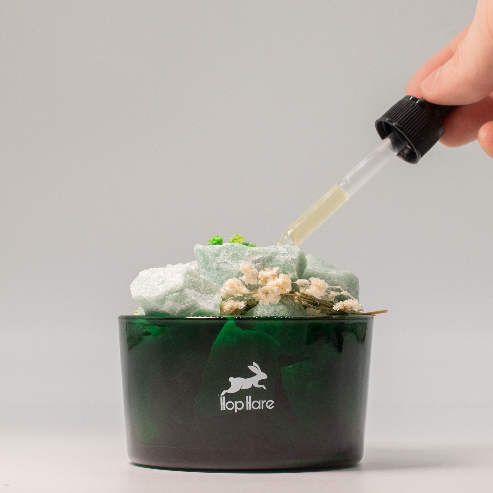 Adding fragrance oil to The Magician Green Aventurine crystal diffuser