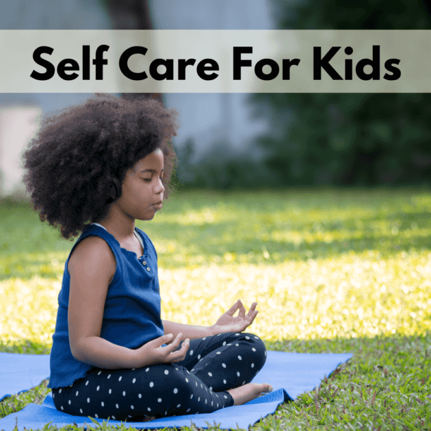 a black child meditating on a yoga mat