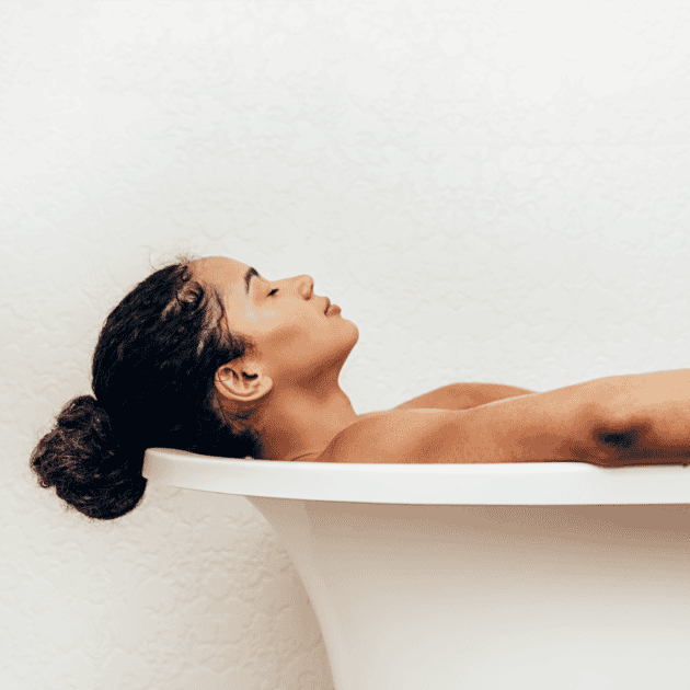 a new mom taking a relaxing bath as self care for new moms