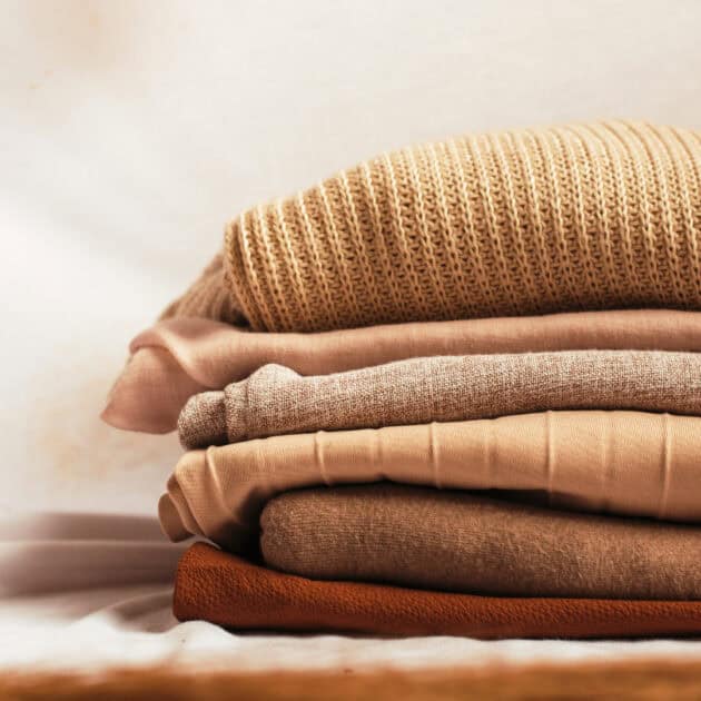 bedroom organizing folded sweaters