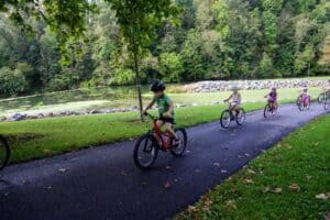 Riders on a shaded greenway trail during the century ride