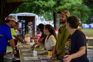 Volunteers helping riders check in at the registration table