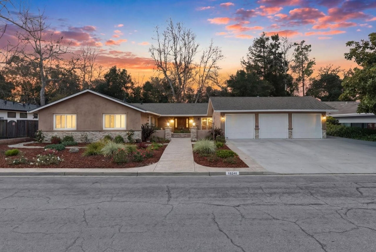 Single-story ranch house at sunset in Saratoga, CA with landscaped yard.