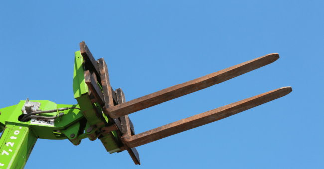 Forklift with tynes in the air