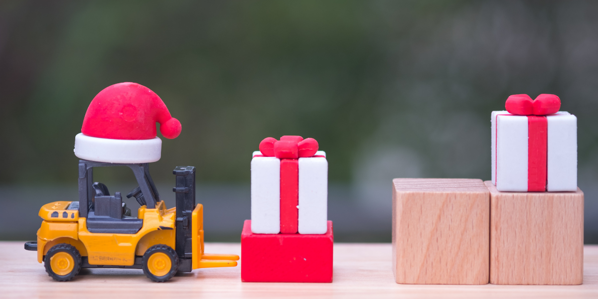 toy forklift with santa hat and wooden block gifts