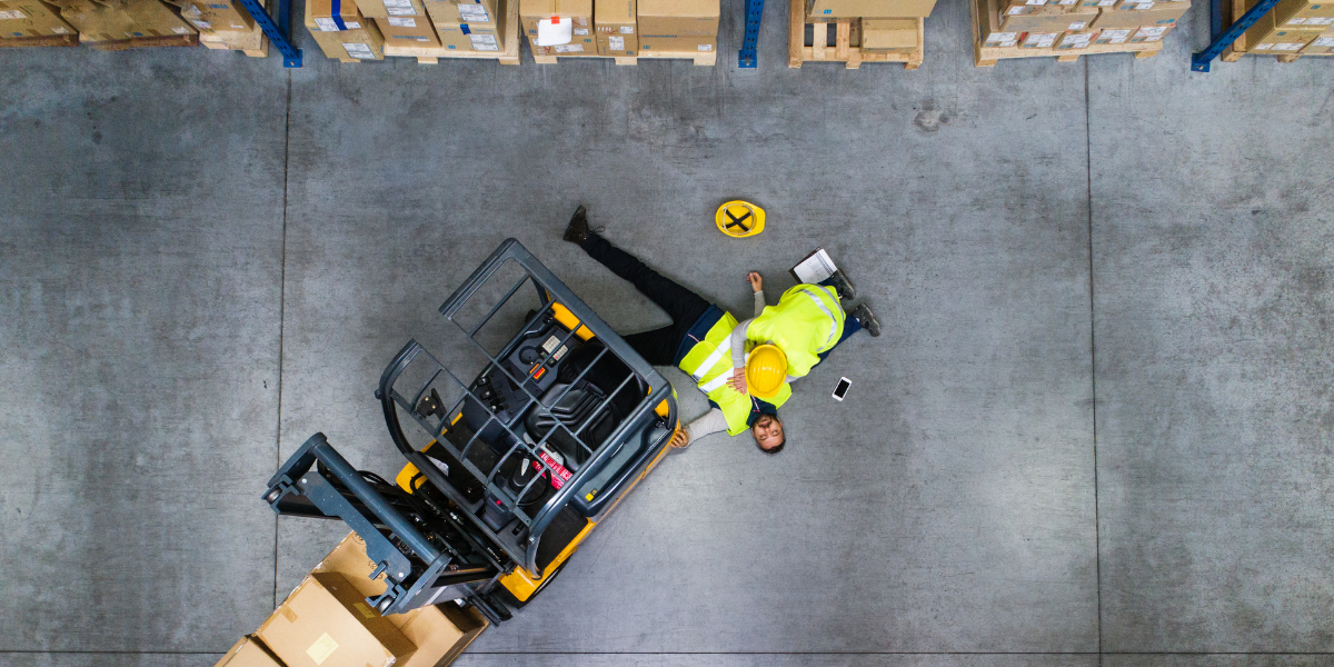 man on the ground after being injured by a forklift
