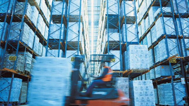 Forklift running with a load in a warehouse