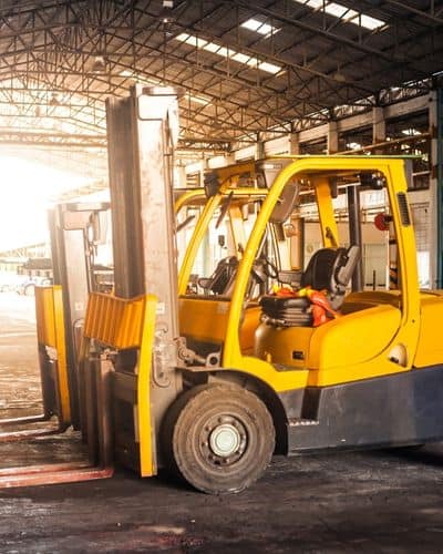 Forklift fleet parked in warehouse