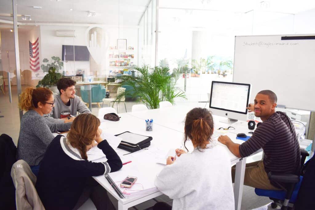 TEFL trainees working around a table during a training session at TEFL Madrid Academy