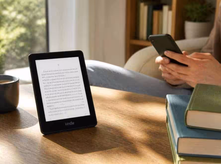 Ebook reader displaying text with a person using a smartphone nearby.