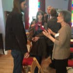 Group of people engaging in conversation at Mayo Street Arts community event.