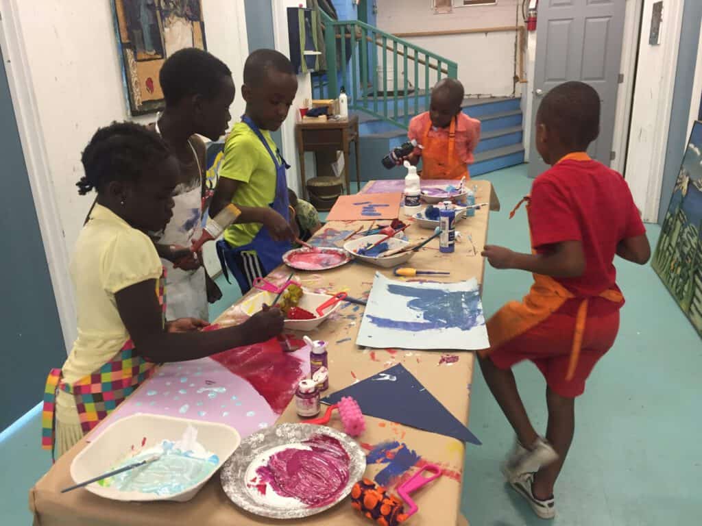 Children engaging in creative art activities at a youth workshop.