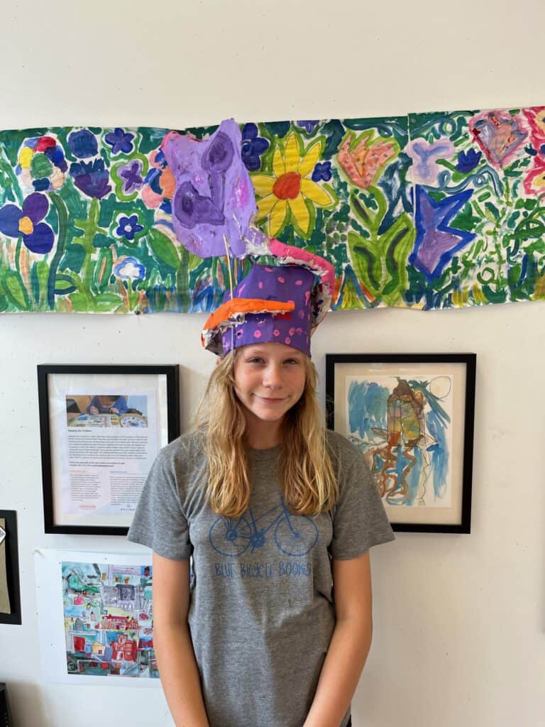 Public art project featuring a young girl with a painted hat, showcasing colorful artwork and inspir.