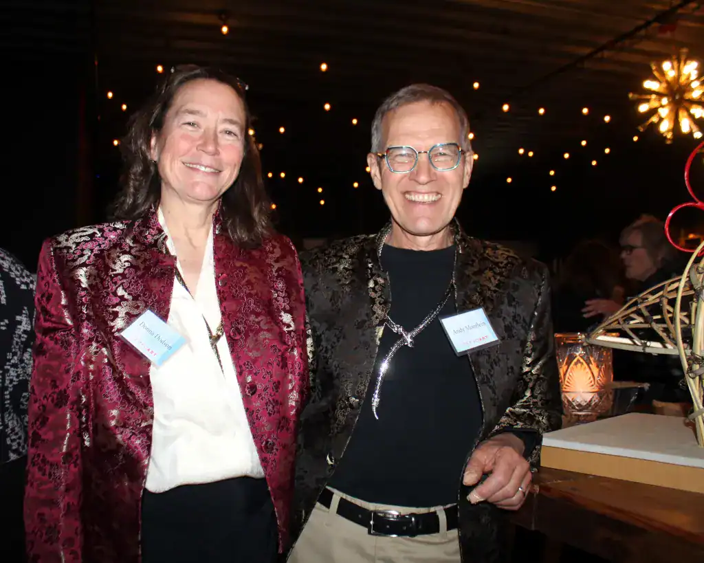 Two smiling women at TEMPOart event supporting public art initiatives.