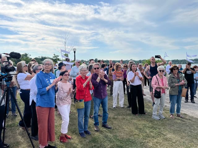 People celebrating and enjoying the community art event outdoors.