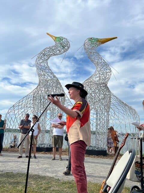 Sculpture of two large intertwined swans at the community opening of "Dancing for Joy".