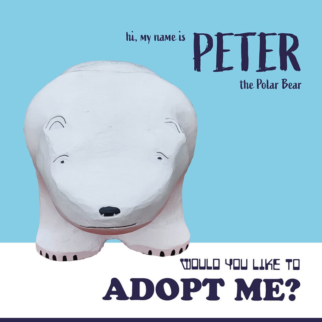 Cute polar bear animal bench sculpture for adoption display.
