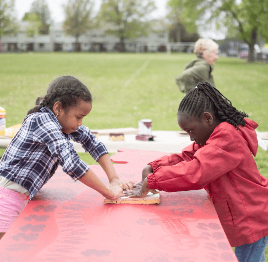 Children engaging in outdoor art activity at TEMPOart event.