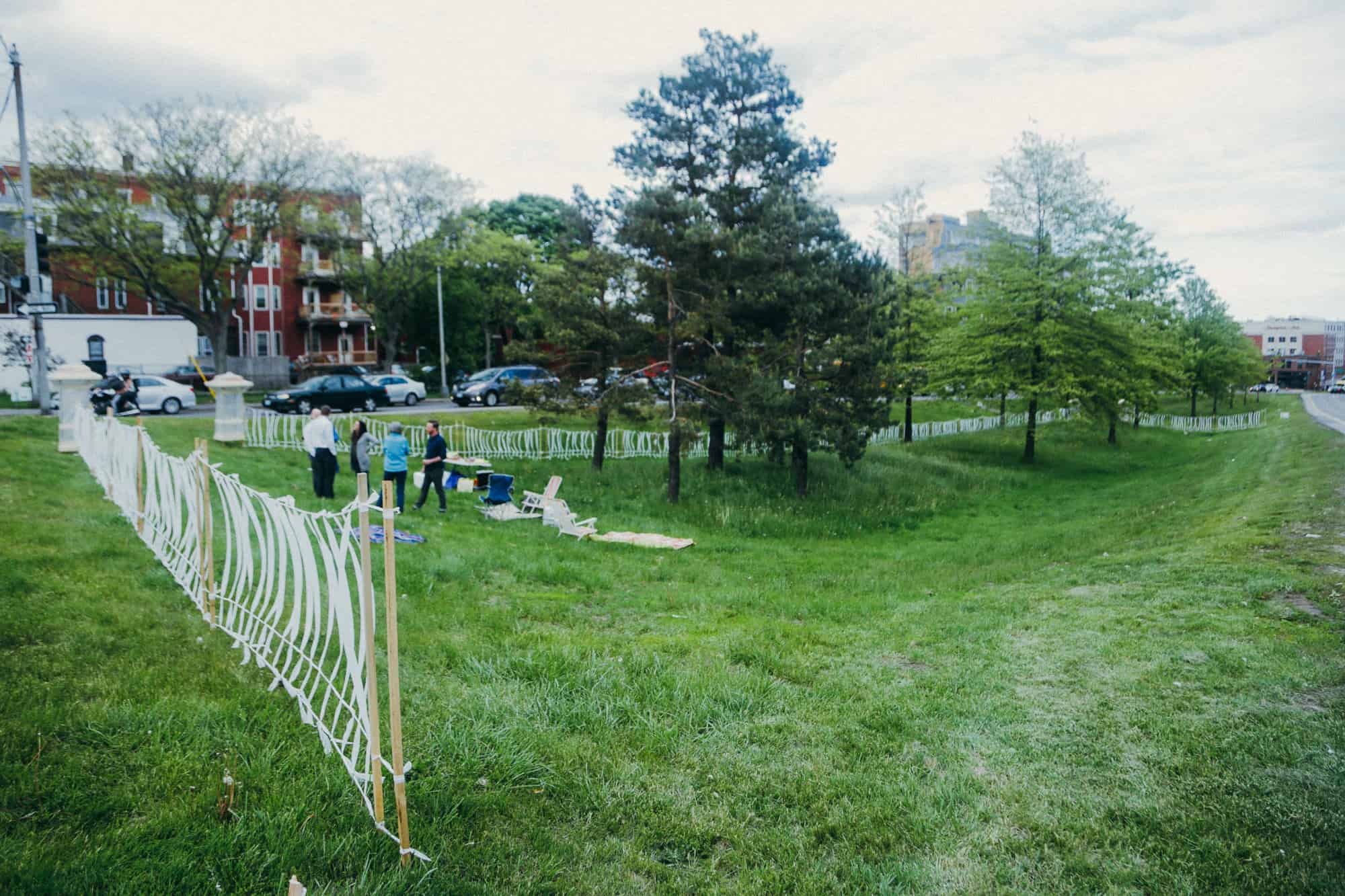 Public art installation in a city park with people observing.