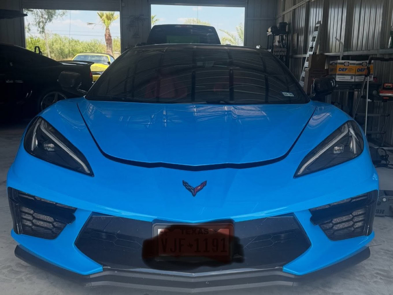 Blue Chevrolet Corvette in auto shop at Texas Tire LLC.