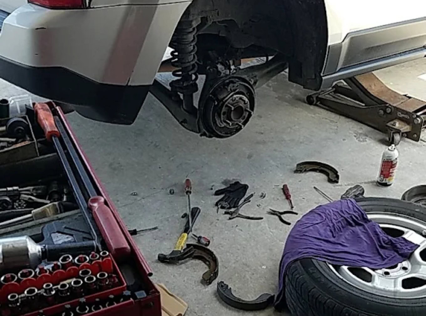 Vehicle wheel removal and brake repair at Texas Automotive & Tire LLC.