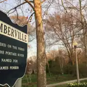Historical sign in Pemberville, Ohio, highlighting the town's founding and connection to the Portage River.