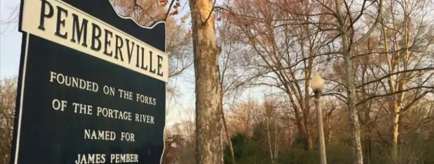 Historical sign in Pemberville, Ohio, highlighting the town's founding and connection to the Portage River.