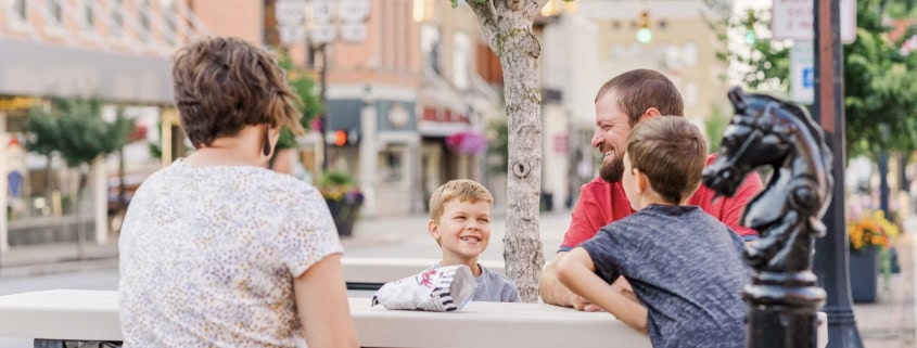 Young family relaxing in central Fostoria, Ohio's lively downtown area.