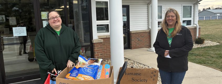 Friendly staff dropping supplies at local animal shelter.