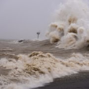 Wild stormy sea waves crashing during severe weather event.
