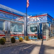 Retro diner with shiny chrome facade and neon "Open" sign.