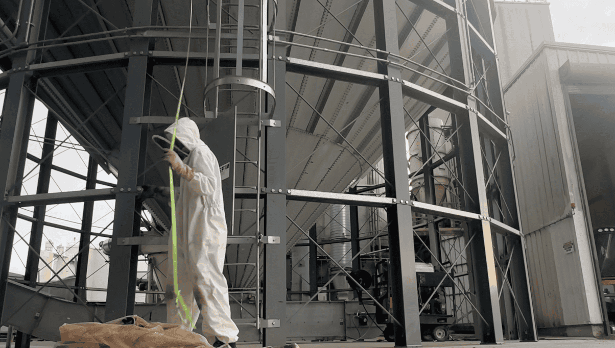 Industrial worker inspecting large industrial structure in Fostoria area.