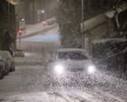 Snow-covered street scene in Fostoria during winter weather.