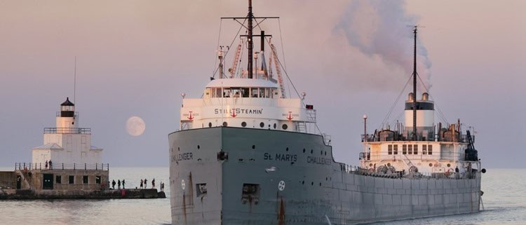 Old steamship docked at harbor during sunset, Fostoria Free Press local news coverage.