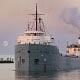Old steamship docked at harbor during sunset, Fostoria Free Press local news coverage.
