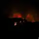 Fire burning in the night sky with smoke, news coverage by The Fostoria Free Press.