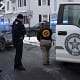 Police officers investigating crime scene with law enforcement vehicles in Fostoria Ohio.