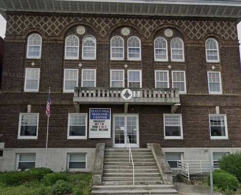 Historic Fostoria Masonic Center building in Ohio, featuring brick architecture and Masonic symbols.