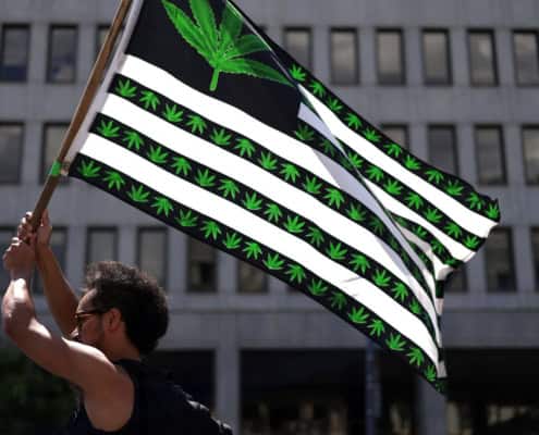 Marijuana flag with cannabis leaf and stripes, urban background.
