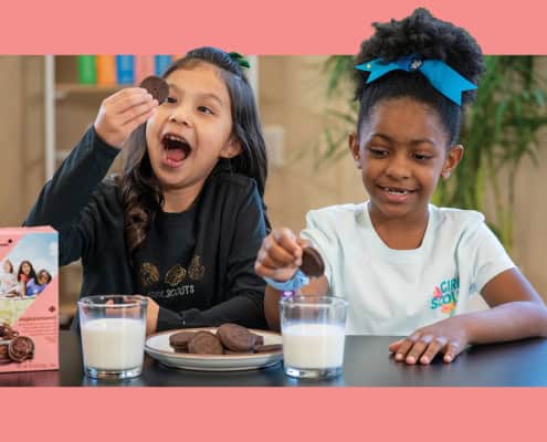 Kids enjoying chocolate cookies with milk, fun snack time, smiling children, Fostoria Free Press.