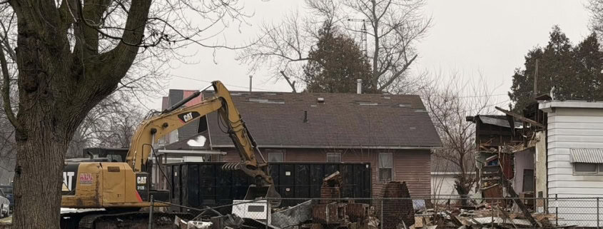 - Excavator demolishing house in Fostoria Ohio, construction, renovation, destruction, local news.