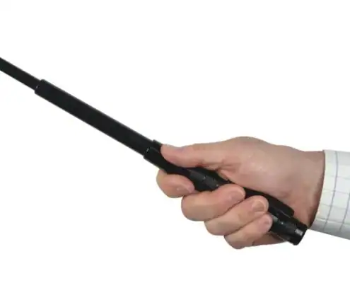 Wireless police baton communication device in hand for security and law enforcement.