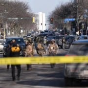 Police scene with officers and crime tape in Fostoria, Ohio, local news coverage.