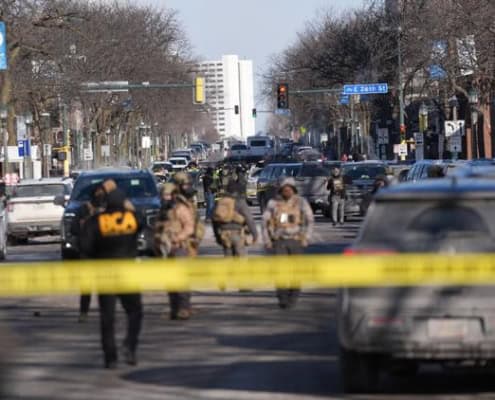 Police scene with officers and crime tape in Fostoria, Ohio, local news coverage.
