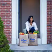 Fresh groceries from Kroger delivered to a happy woman at her doorstep.